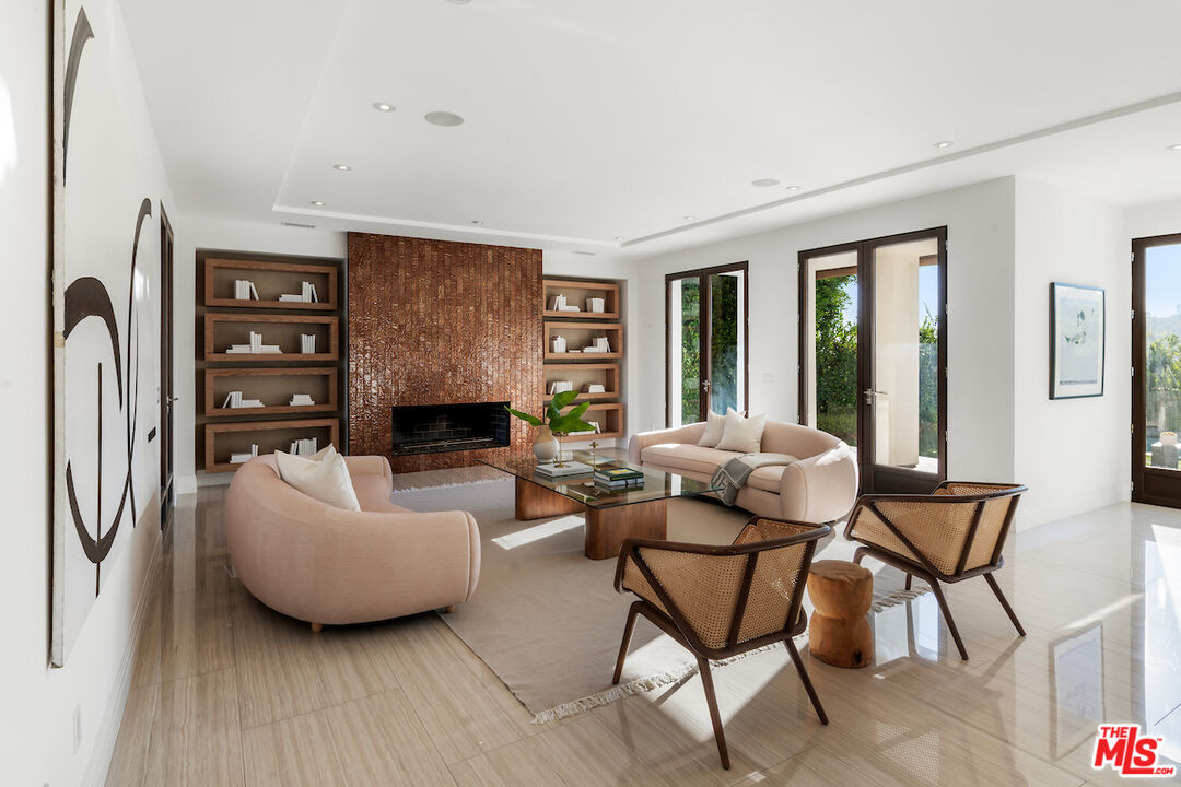 1280 Angelo Drive Beverly Hills, CA 90210 - Photo 15 of 66 a living room with furniture and a fireplace