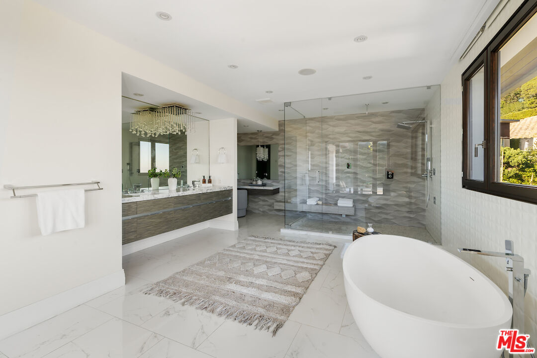 1280 Angelo Drive Beverly Hills, CA 90210 - Photo 37 of 66 a spacious bathroom with a granite countertop tub sink and mirror