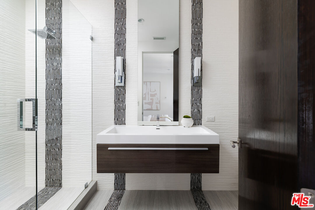 1280 Angelo Drive Beverly Hills, CA 90210 - Photo 44 of 66 a bathroom with a sink and a mirror