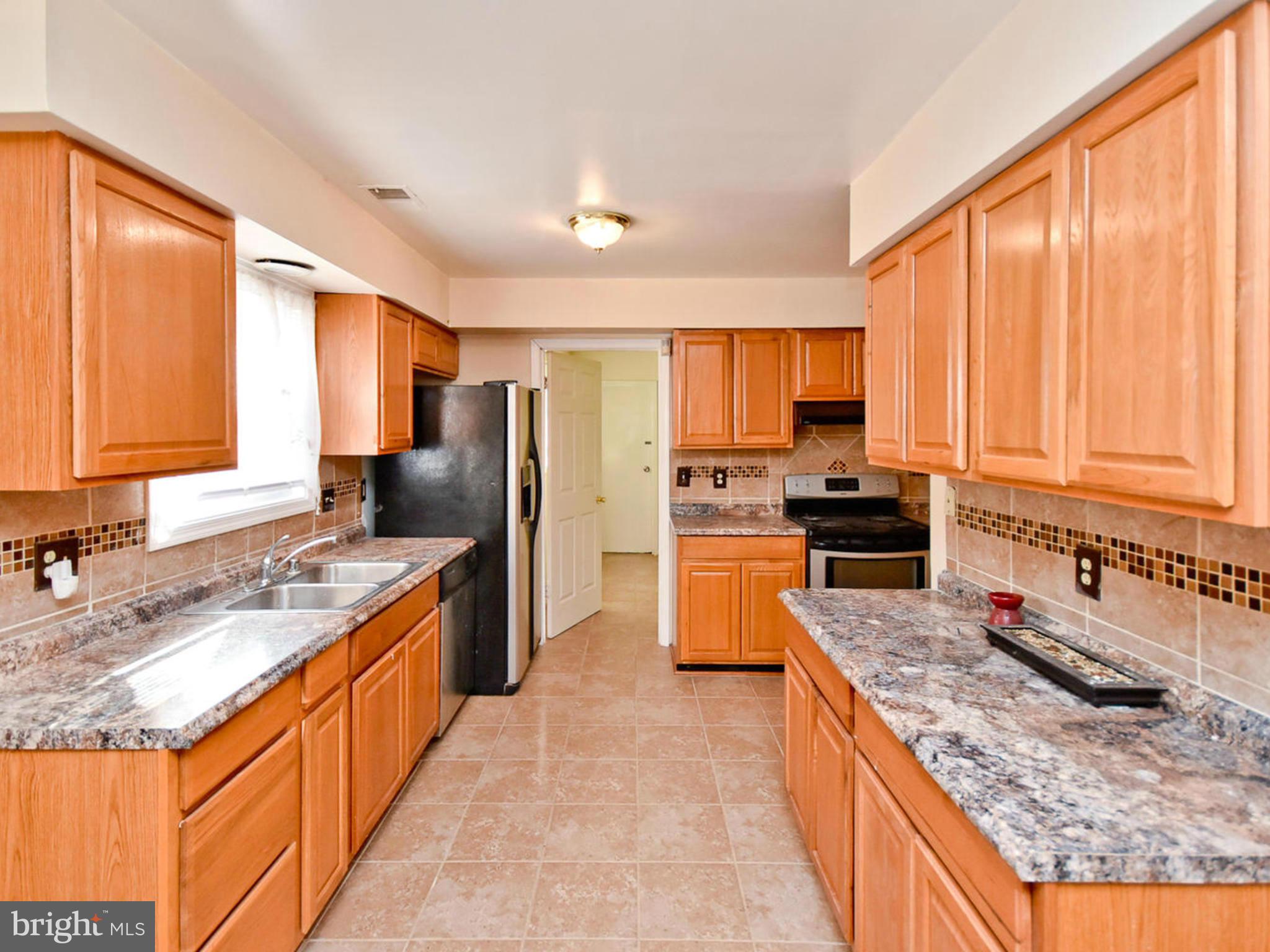 9114 Overlook Trail Fort Washington, MD 20744 - Photo 9 of 27 a kitchen with stainless steel appliances granite countertop a stove top oven a sink dishwasher a refrigerator and a oven