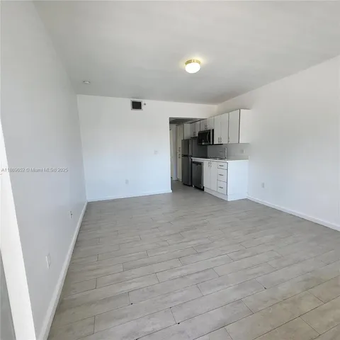 a view of a kitchen with a sink and dishwasher stove top oven