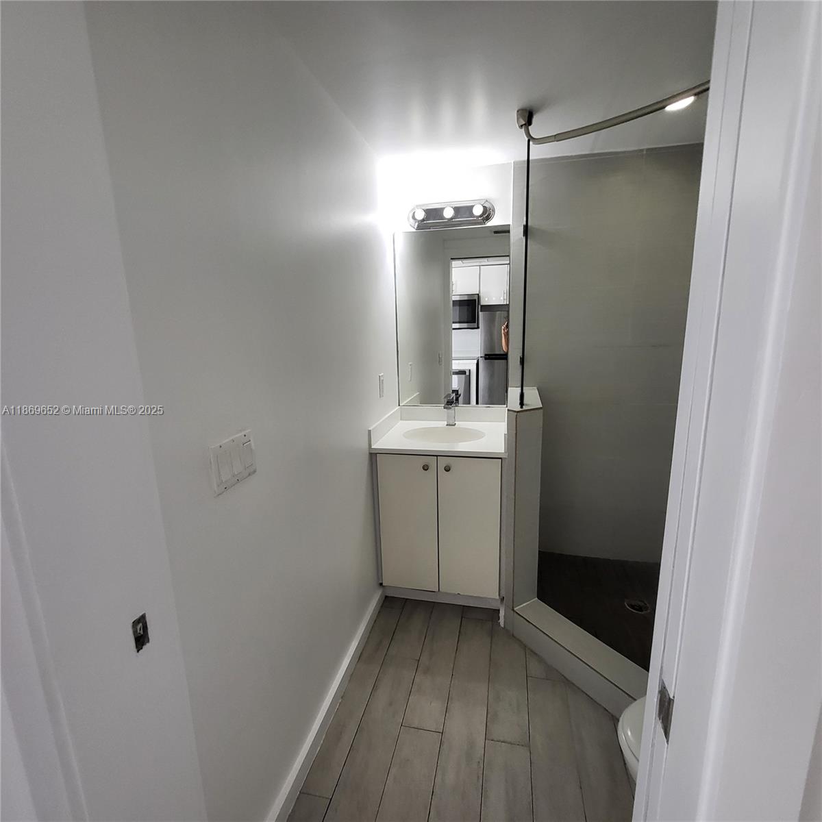 1601 Meridian Avenue, Unit 209 Miami Beach, FL 33139 - Photo 6 of 20 a bathroom with a sink a toilet and shower