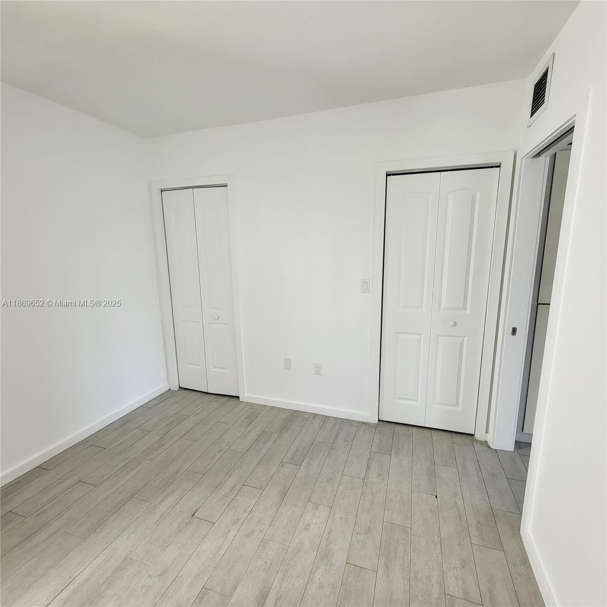 1601 Meridian Avenue, Unit 209 Miami Beach, FL 33139 - Photo 9 of 20 a view of an empty room with wooden floor