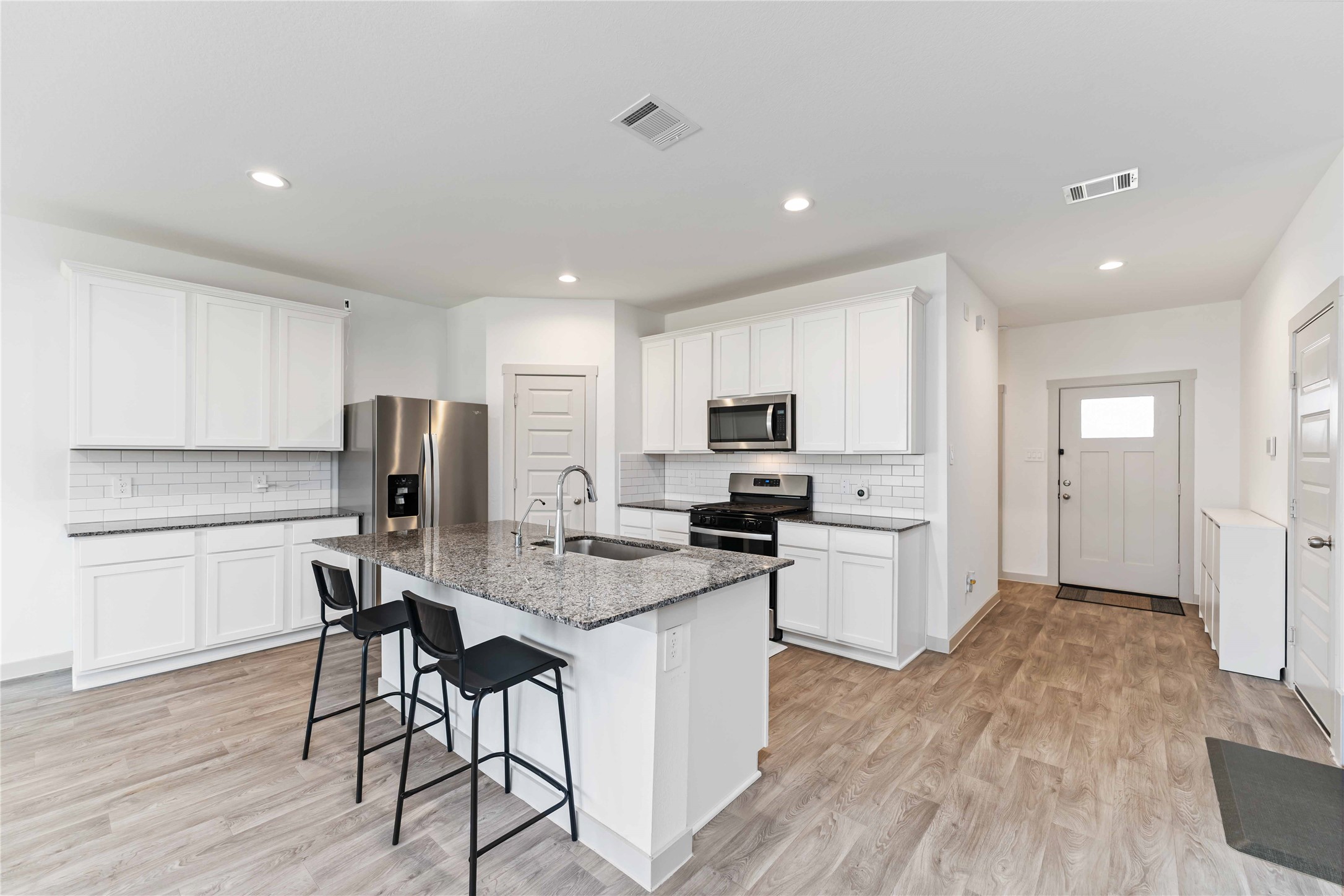 10610 Kings River Drive Rosharon, TX 77583 - Photo 4 of 33 a kitchen with stainless steel appliances a refrigerator a stove a sink dishwasher and a refrigerator with wooden floor