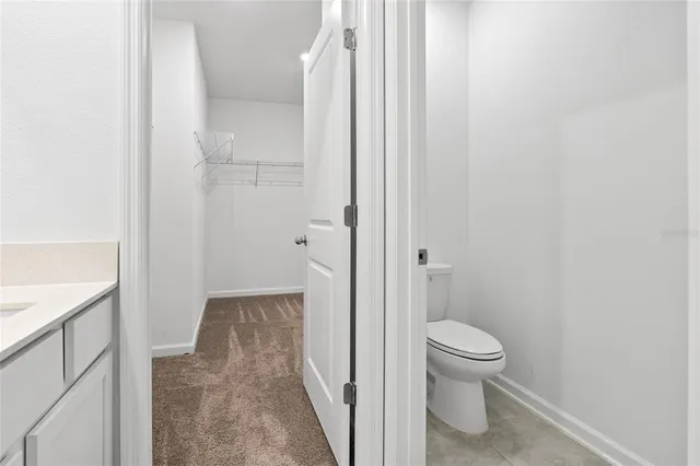 a bathroom with a granite countertop toilet
