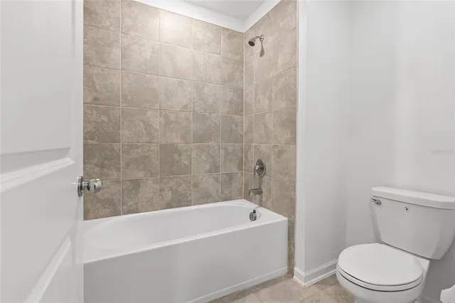 a white bath tub sitting next to a toilet
