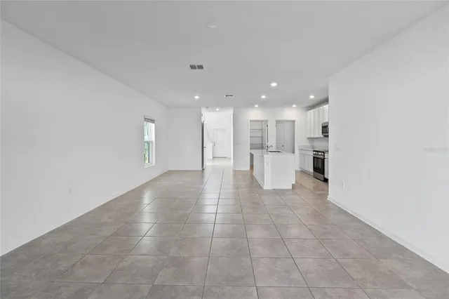 a view of a big room with windows and a chandelier