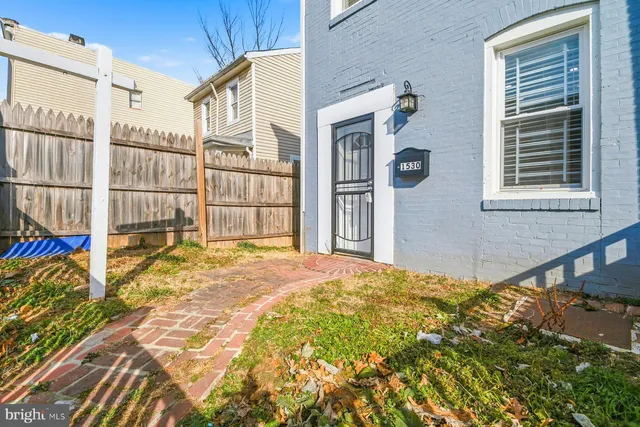 a view of a house with a small backyard