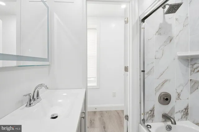 a bathroom with a sink and shower