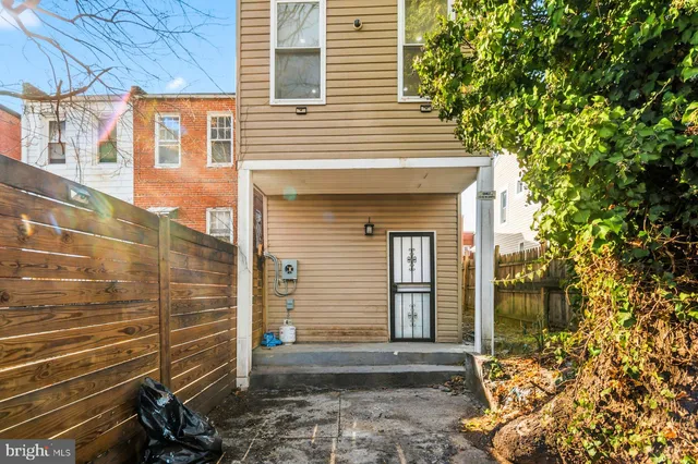 a view of a house with a door and wooden walls
