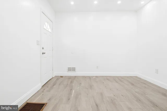 a view of a room with wooden floor