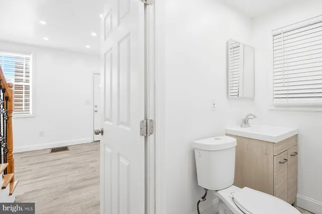 a white toilet sitting next to a bathroom sink