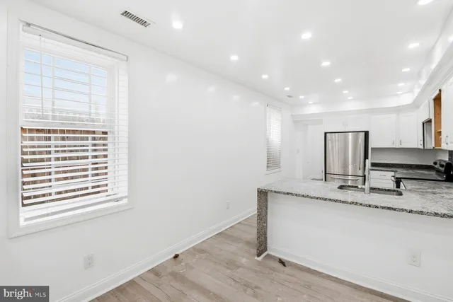 a view of kitchen with granite countertop window