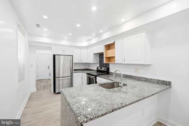 a kitchen with refrigerator and window