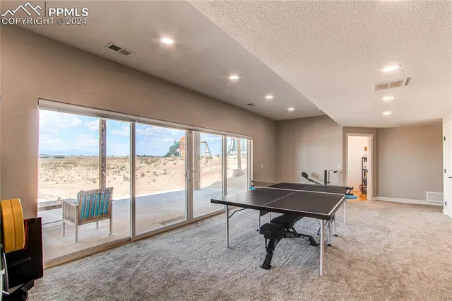 a large room with gym equipment and a large mirror