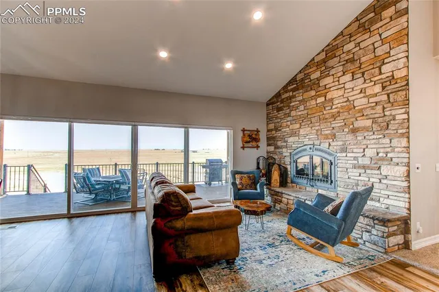 an outdoor living room with patio furniture and a fireplace