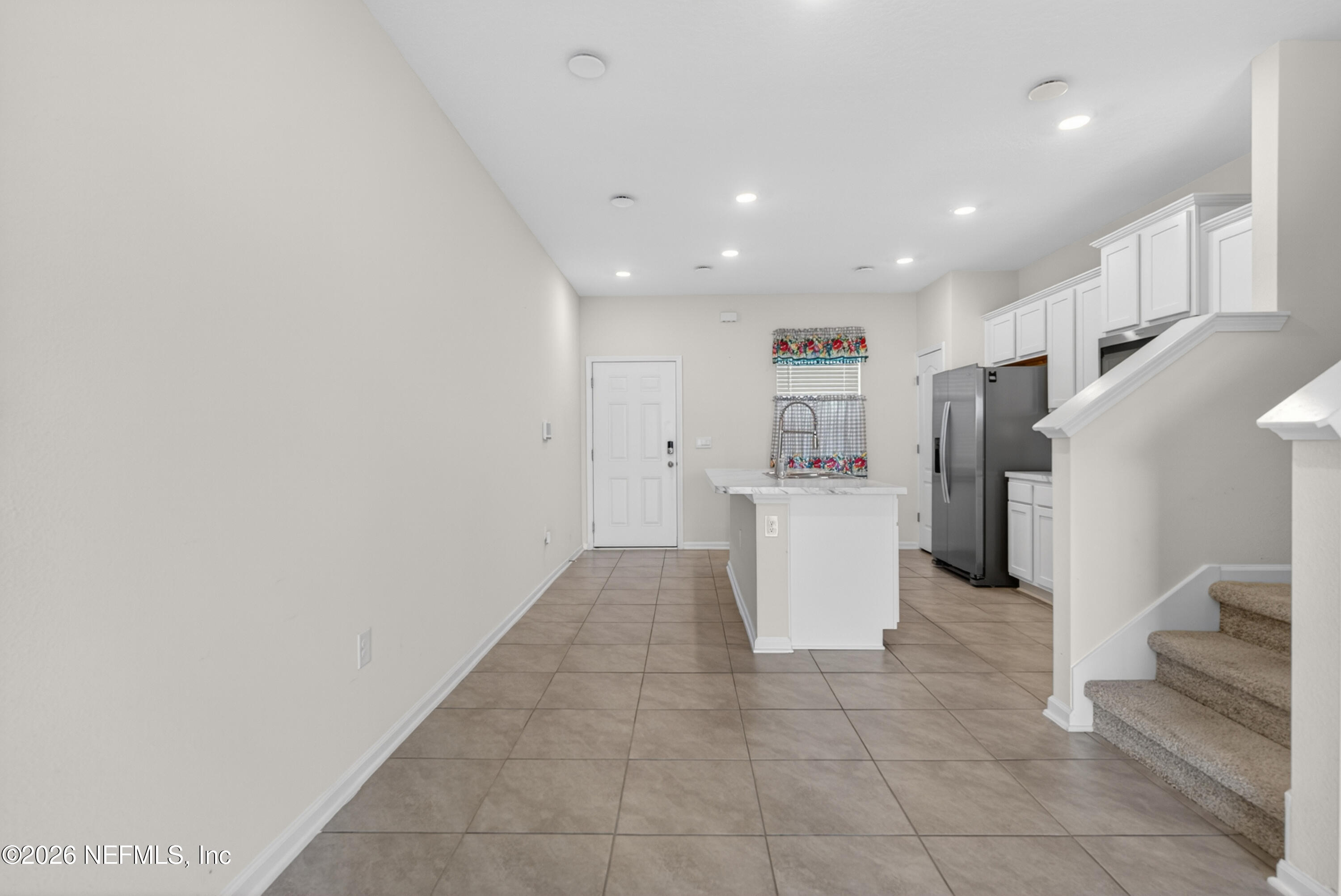 8210 Larose Road Jacksonville, FL 32211 - Photo 9 of 38 a view of a kitchen with refrigerator and white cabinets