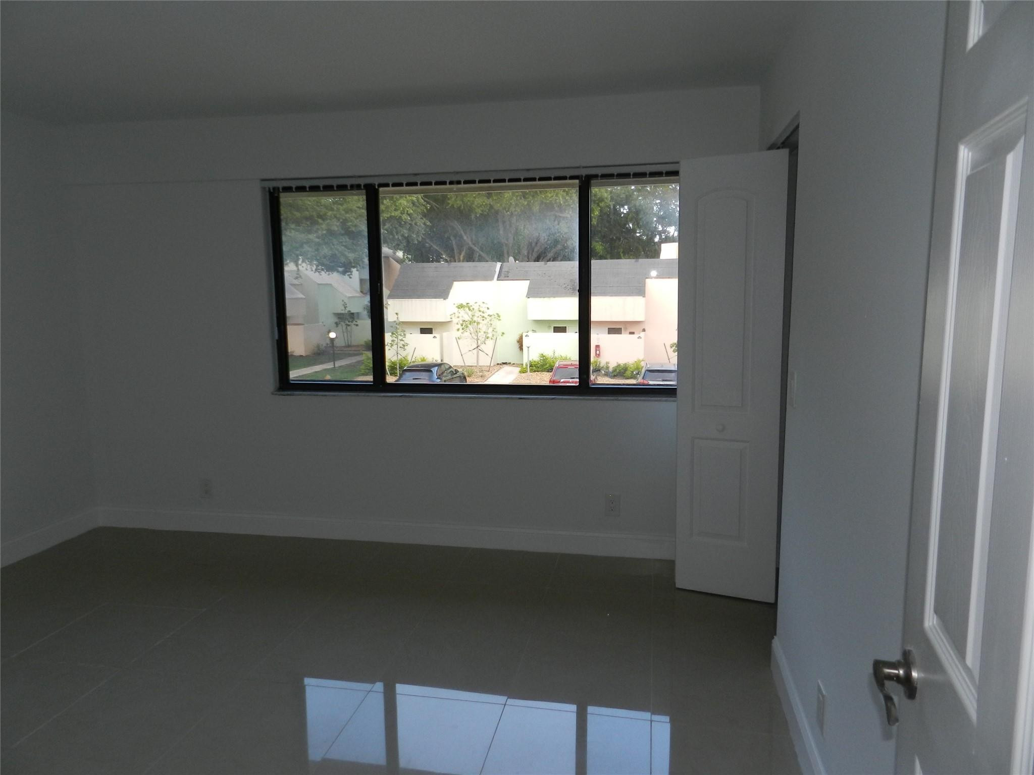 73 Deer Creek Road, Unit 103 Deerfield Beach, FL 33442 - Photo 21 of 28 Second Bedroom Looking Out