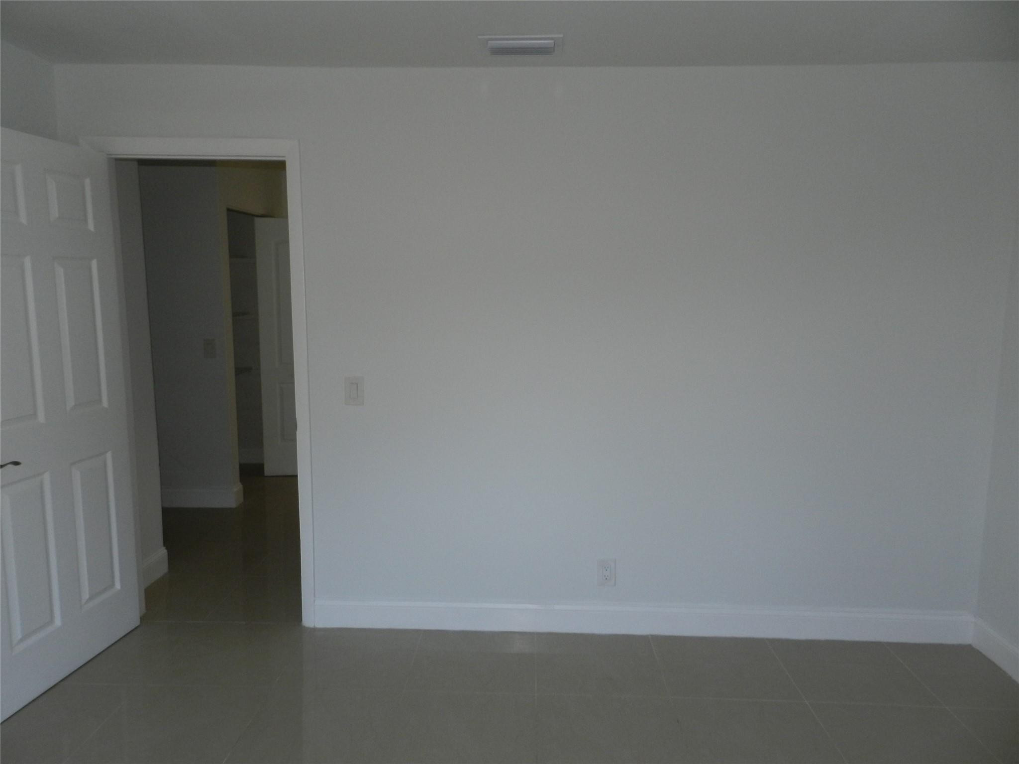 73 Deer Creek Road, Unit 103 Deerfield Beach, FL 33442 - Photo 25 of 28 Second Bedroom going to hallway