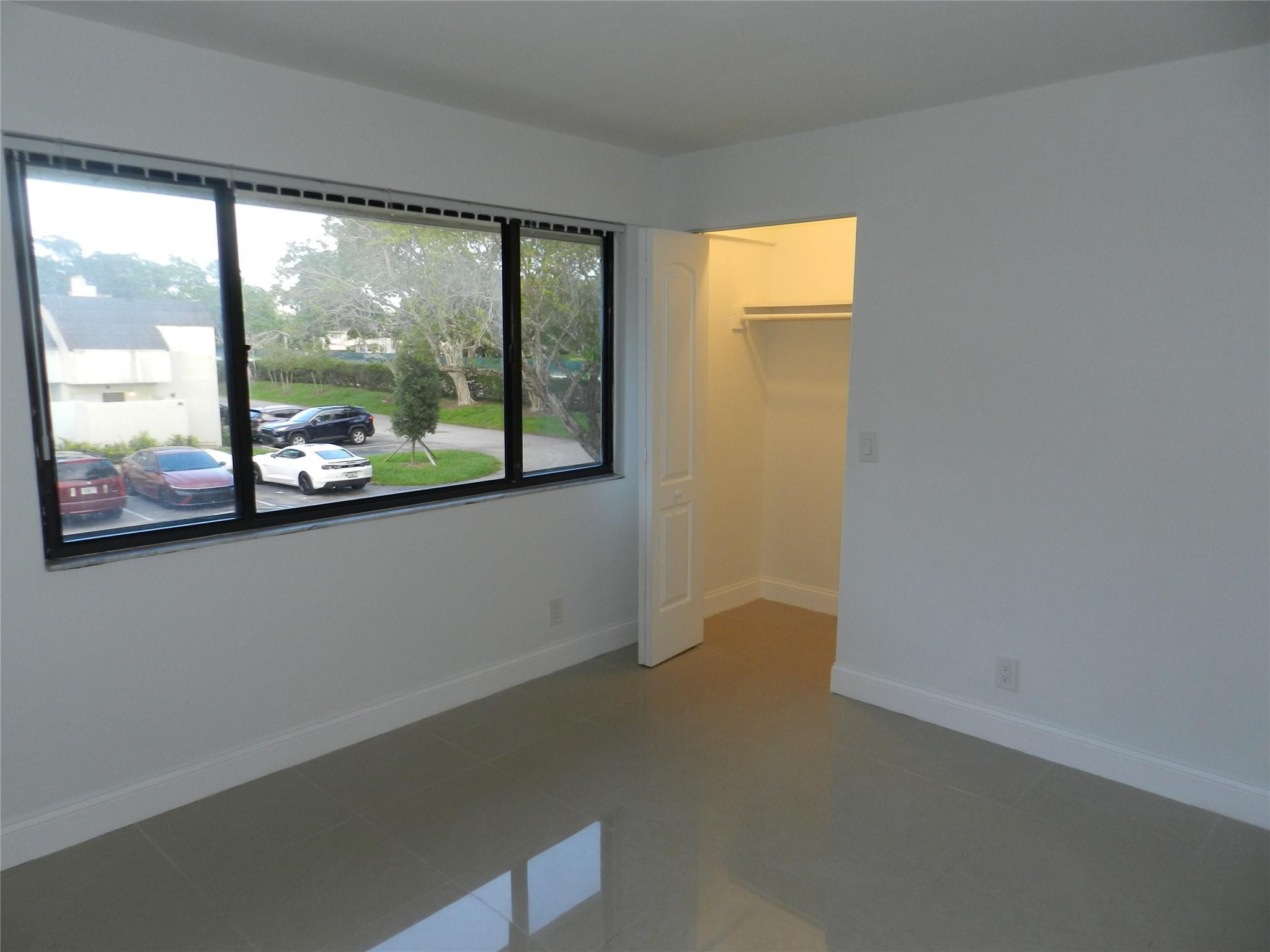 73 Deer Creek Road, Unit 103 Deerfield Beach, FL 33442 - Photo 27 of 28 Second Bedroom Looking Out w/Closet