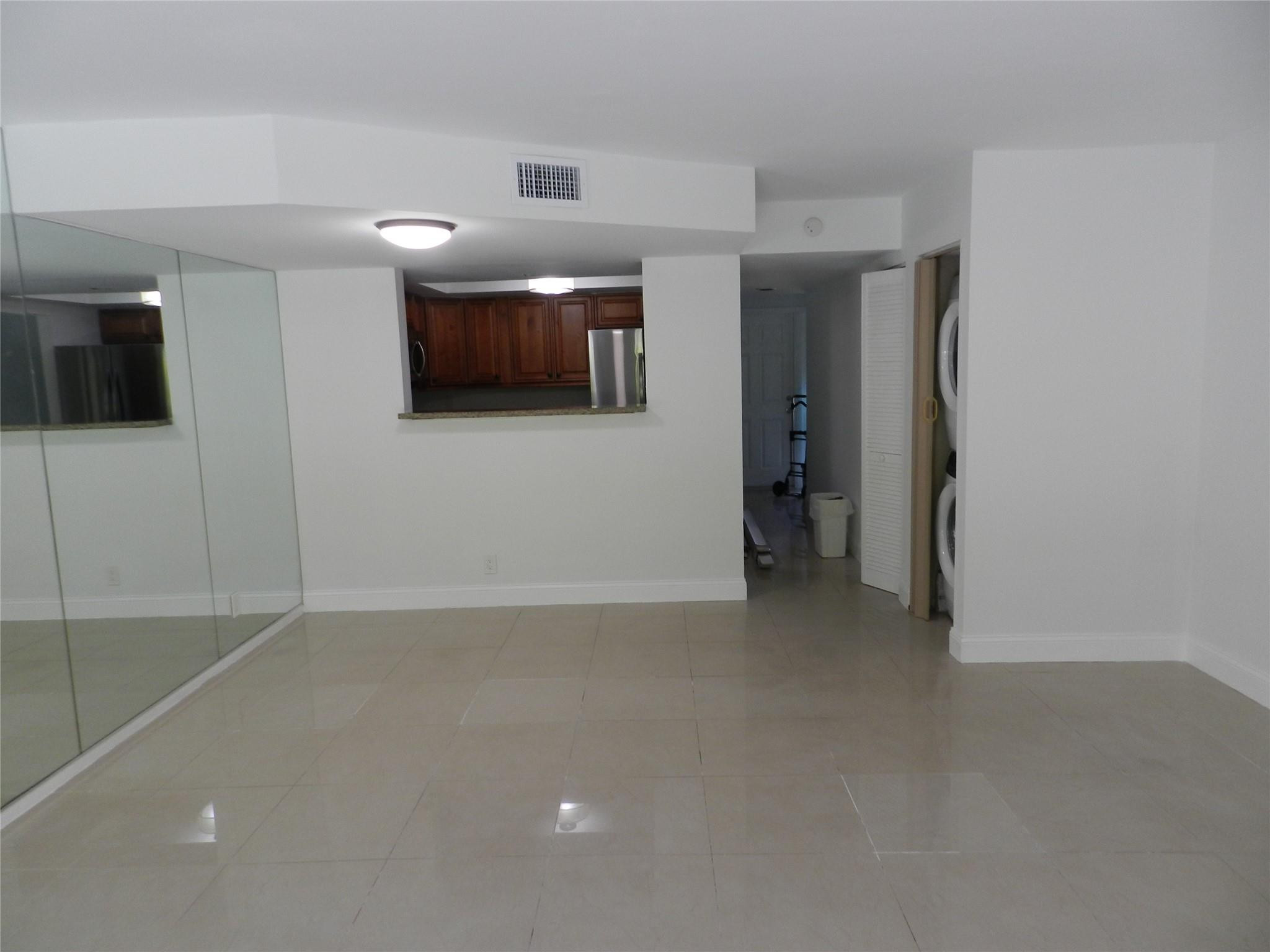 73 Deer Creek Road, Unit 103 Deerfield Beach, FL 33442 - Photo 6 of 28 Living Room Facing Kitchen Pass-through