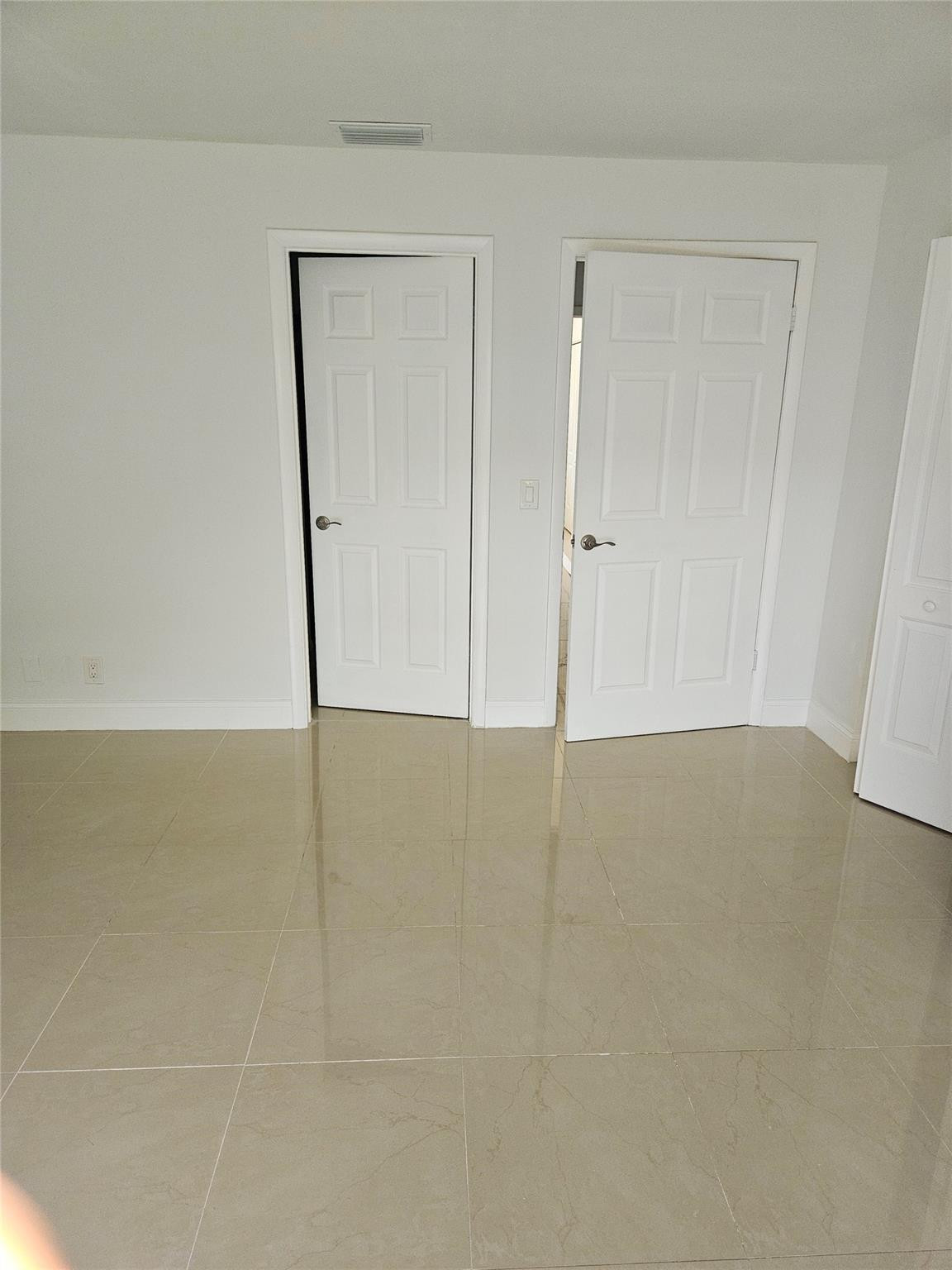 73 Deer Creek Road, Unit 103 Deerfield Beach, FL 33442 - Photo 9 of 28 Primary Bedroom/Exit and Bathroom Door