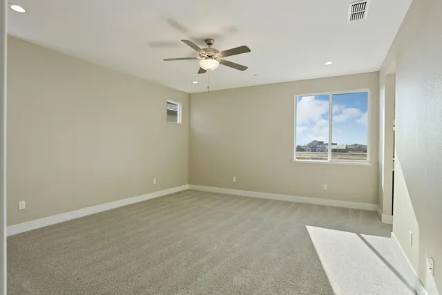 a bedroom with a bed and ceiling fan