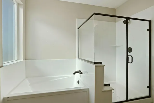 a bathroom with a double vanity sink mirror double and shower