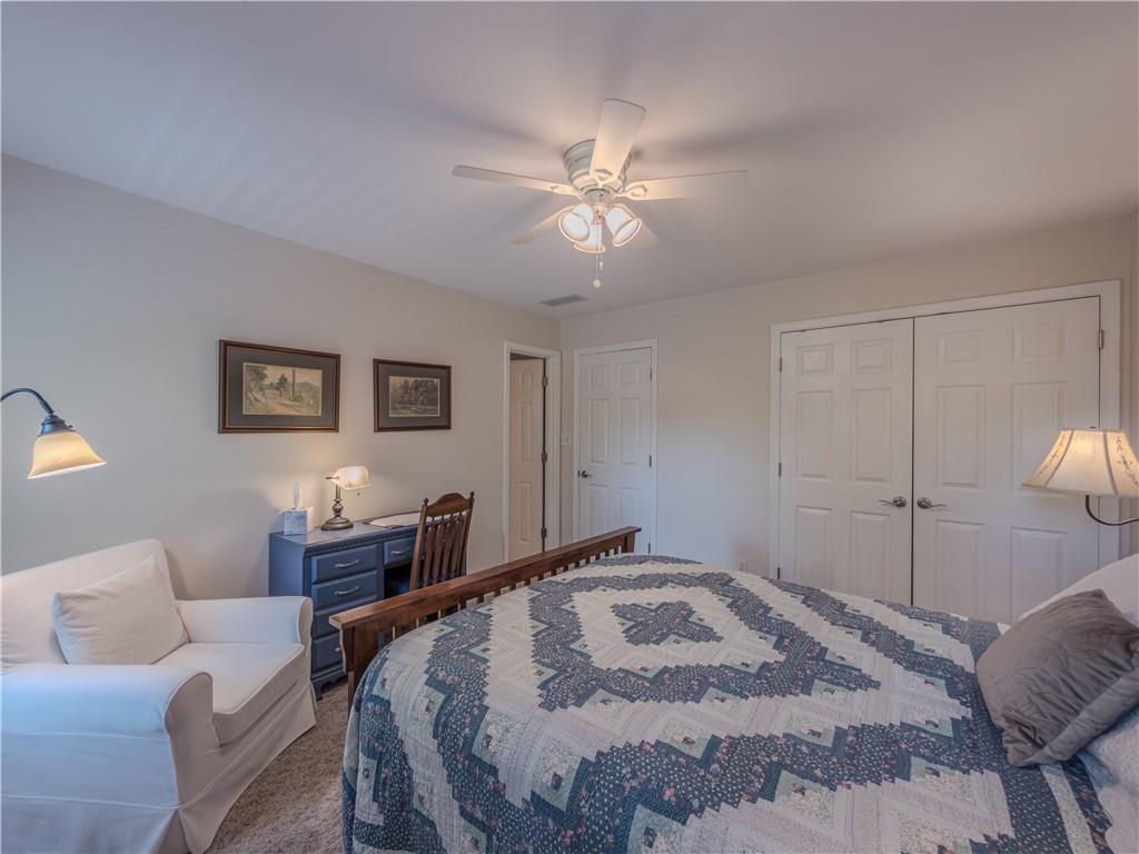 4284 Cedar Bluff Way Southwest Lilburn, GA 30047 - Photo 44 of 62 a bedroom with a large bed couch and a window