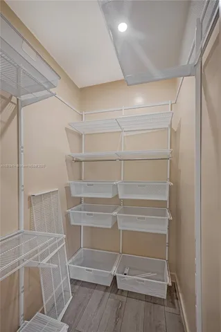 a view of walk in closet with empty racks