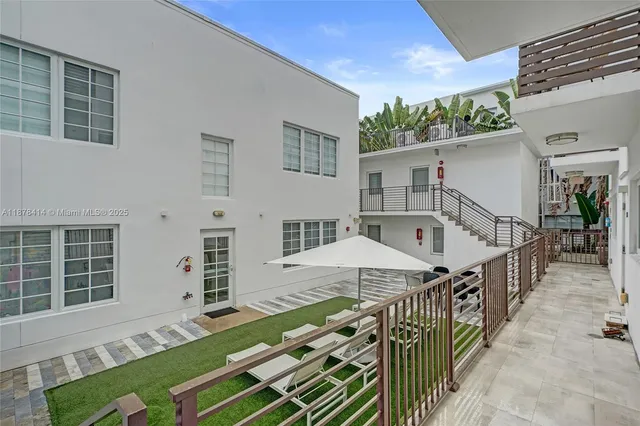 a roof deck with table and chairs