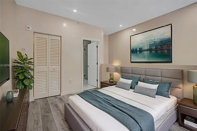 a bedroom with bed and a potted plant