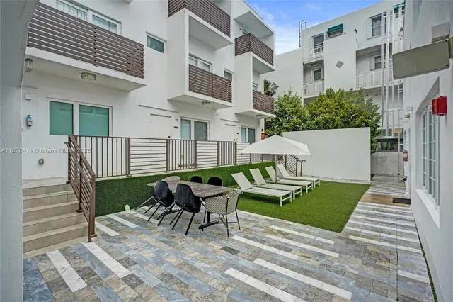 a view of a patio with a table and chairs