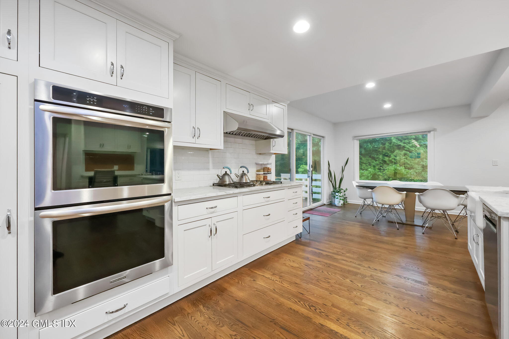 68 Willowmere Circle Riverside, CT 06878 - Photo 7 of 29 a kitchen with a stove a microwave and white cabinets