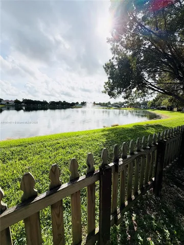 an aerial view of ocean with residential house and outdoor space