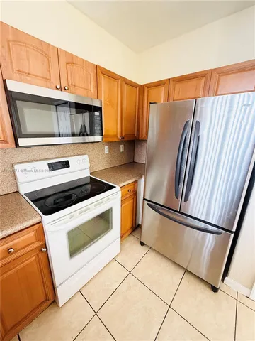 a kitchen with appliances and cabinets