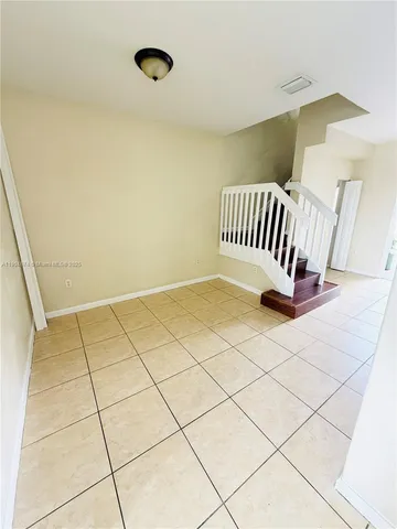 a view of an empty room and wooden floor