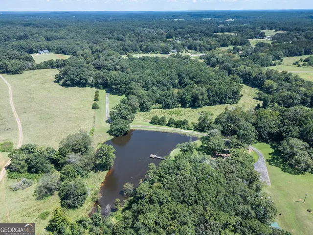 a kitchen with stainless steel appliances granite countertop a table chairs and a large window