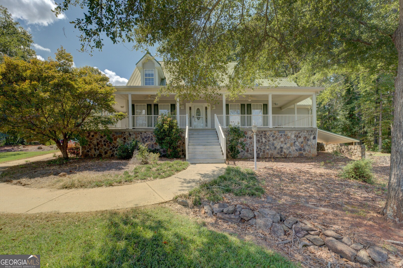 925 Highway 36 East Jackson, GA 30233 - Photo 14 of 90 a front view of a house with a garden and trees