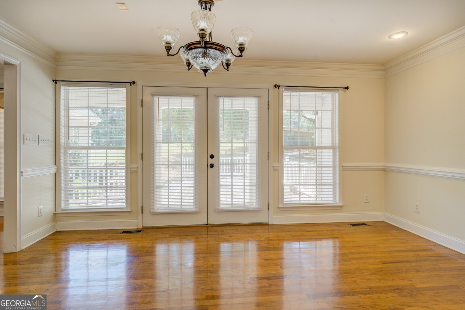 925 Highway 36 East Jackson, GA 30233 - Photo 22 of 90 a view of an empty room with wooden floor and a window