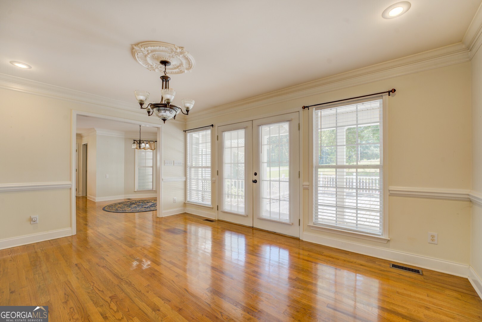 925 Highway 36 East Jackson, GA 30233 - Photo 26 of 90 a view of an empty room with wooden floor and a window
