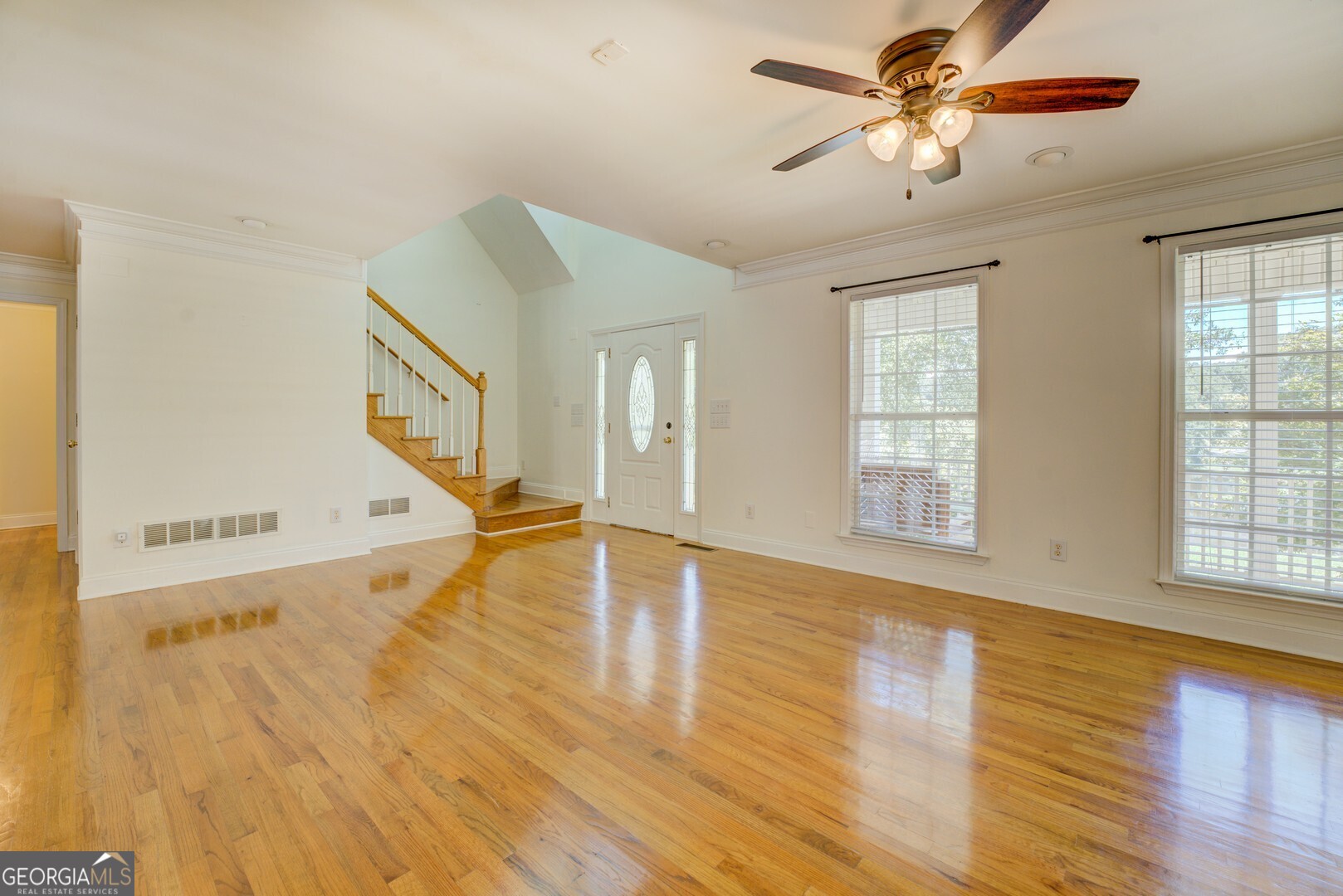 925 Highway 36 East Jackson, GA 30233 - Photo 27 of 90 a view of an empty room with wooden floor and a window