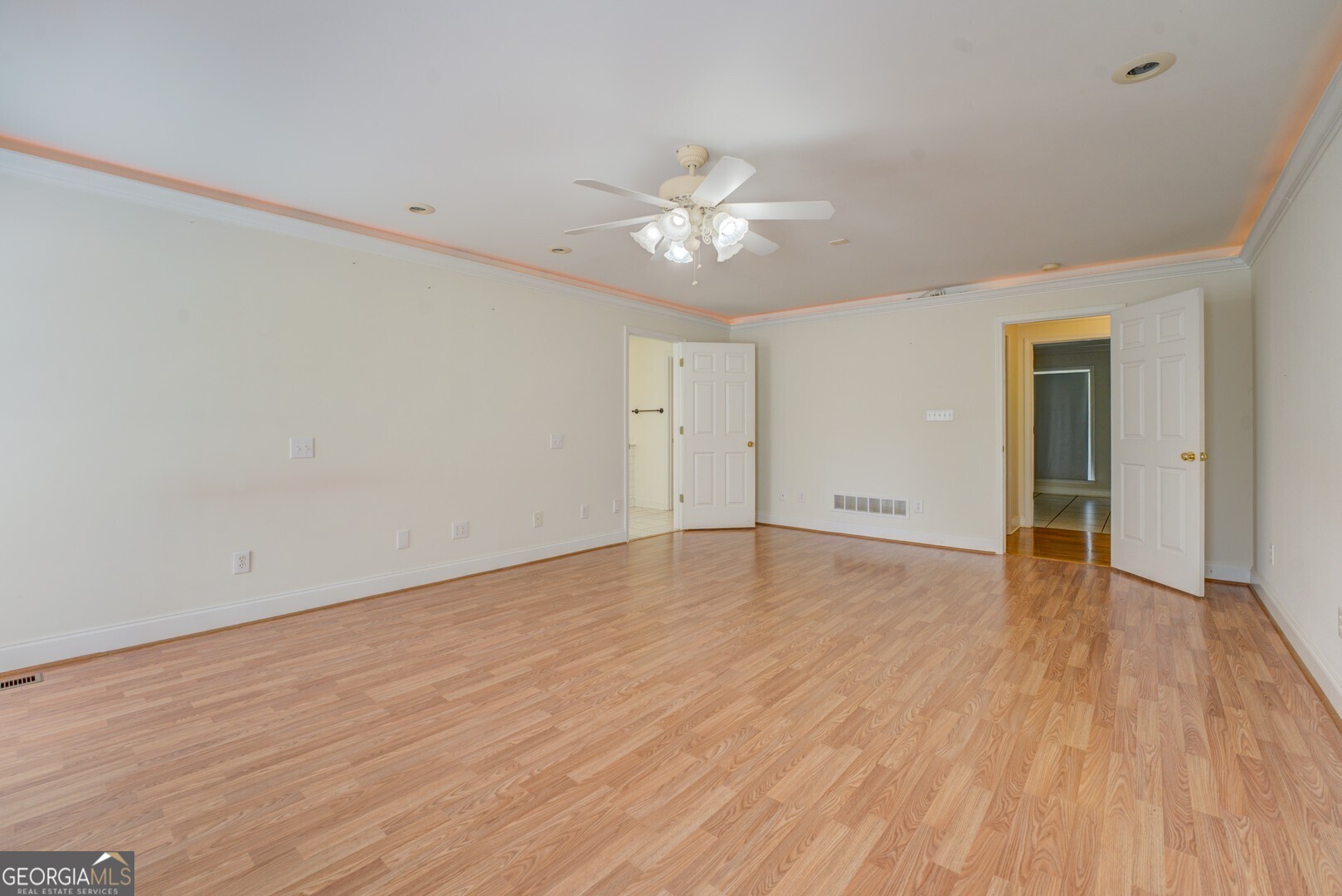 925 Highway 36 East Jackson, GA 30233 - Photo 29 of 90 a view of an empty room with wooden floor and a ceiling fan