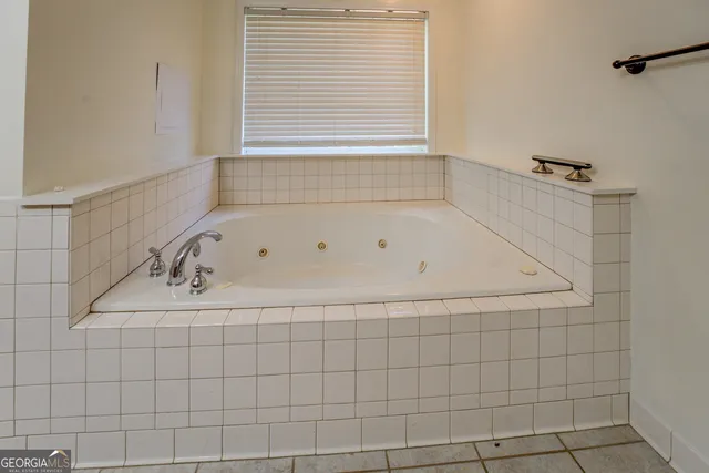 an aerial view of a house with a yard and lake view