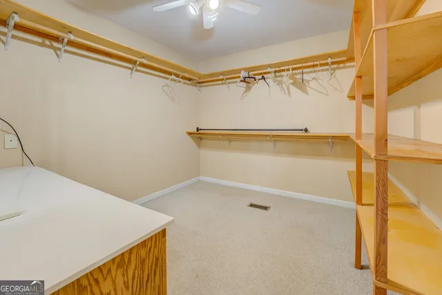 an aerial view of a house with a yard and lake view