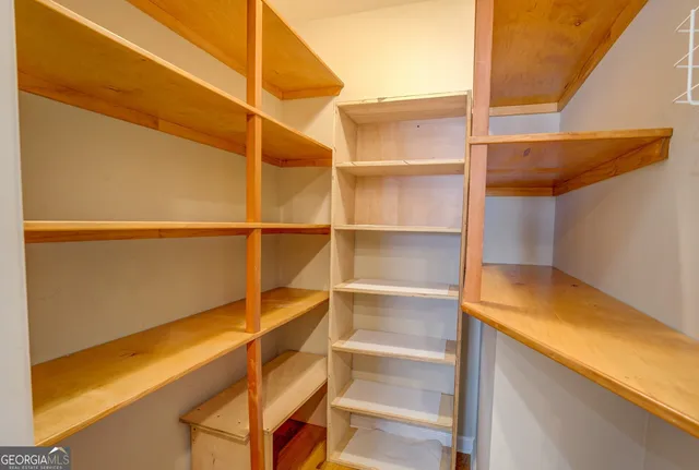 an aerial view of a house with a yard and lake view