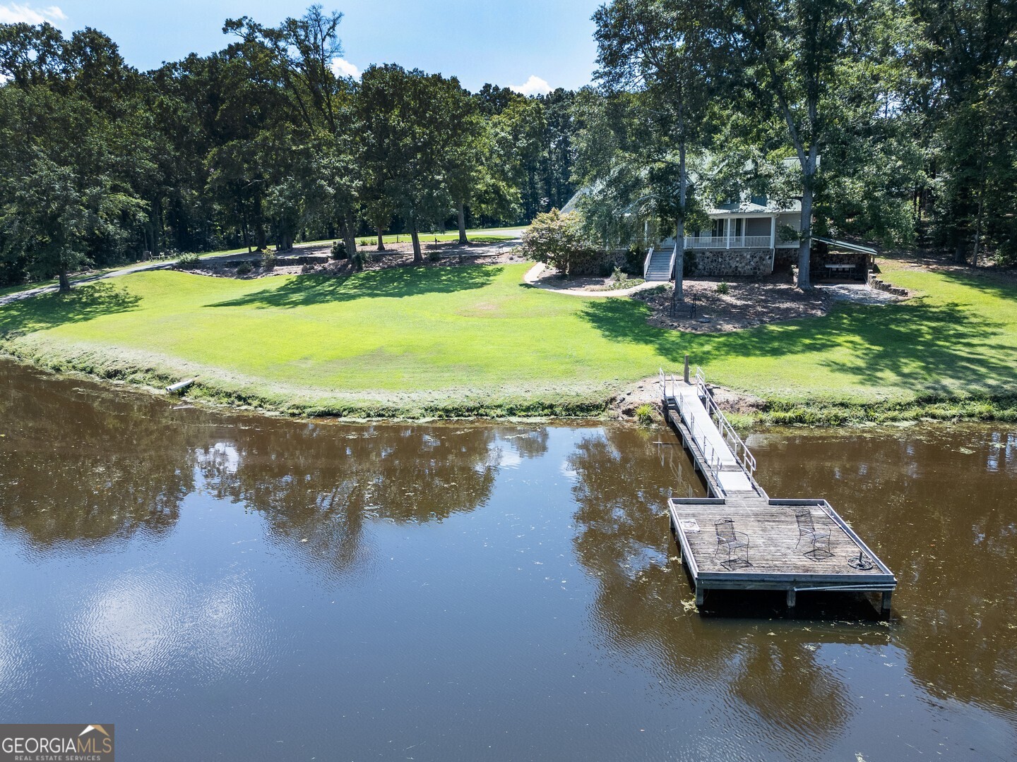925 Highway 36 East Jackson, GA 30233 - Photo 5 of 90 a view of a lake with lawn chairs and a large tree