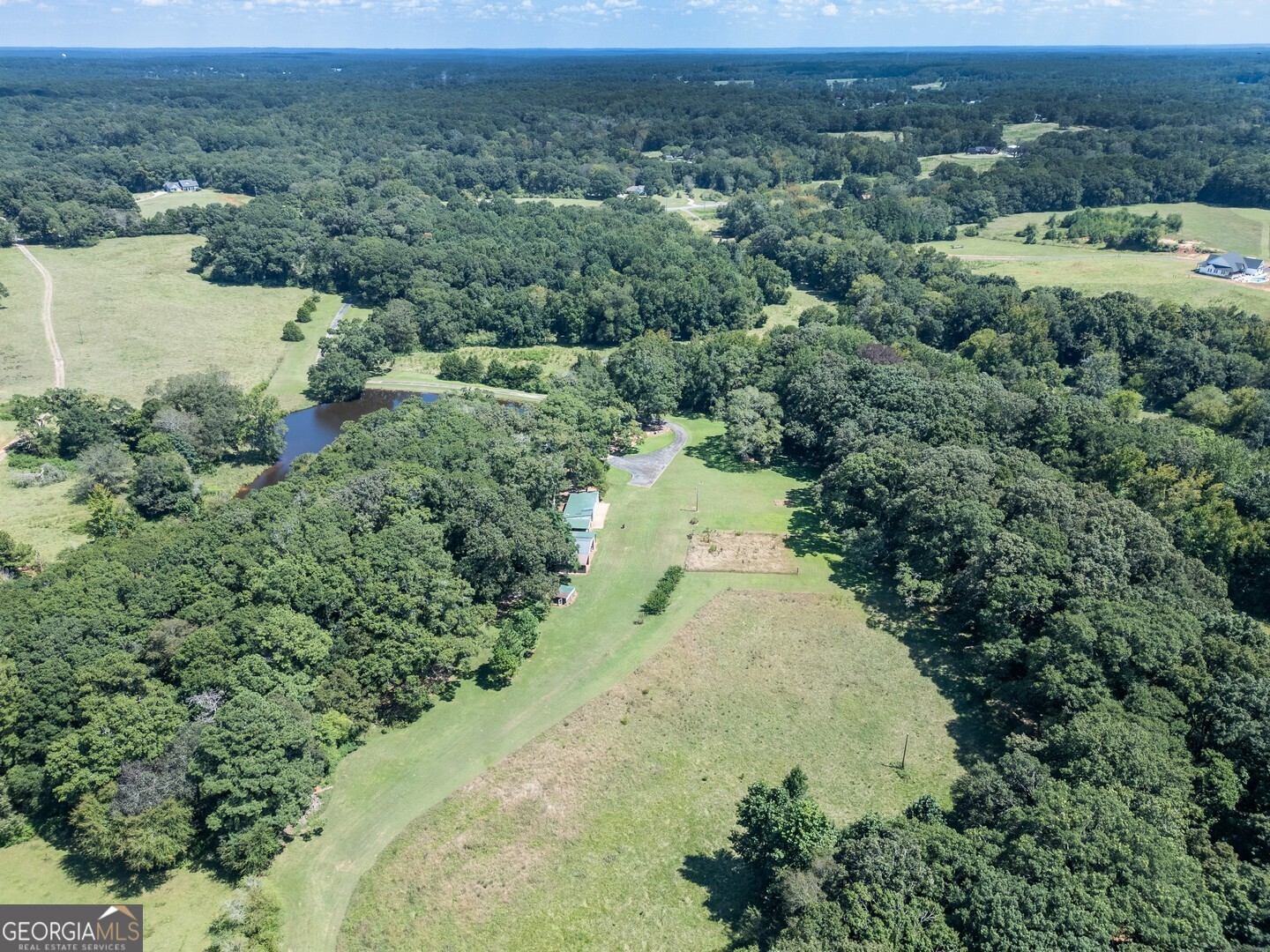 925 Highway 36 East Jackson, GA 30233 - Photo 79 of 90 an aerial view of a houses with a yard and lake view