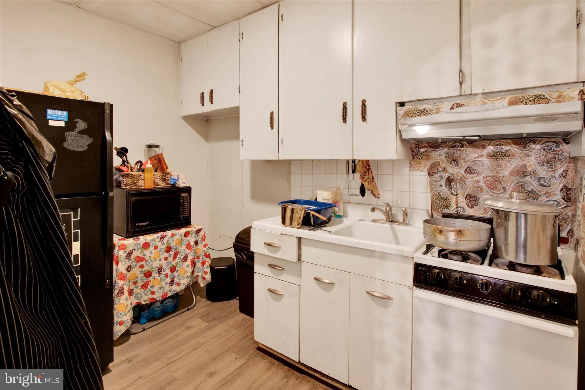 238 South 5th Street Reading, PA 19602 - Photo 16 of 28 a kitchen with stainless steel appliances a stove a sink and a refrigerator