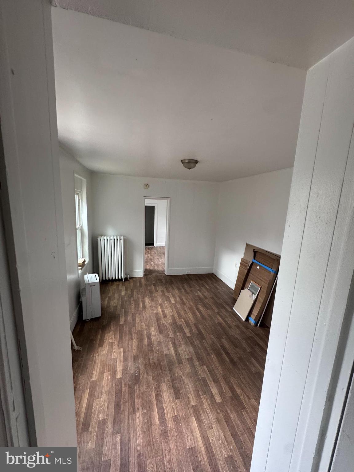 238 South 5th Street Reading, PA 19602 - Photo 22 of 28 a bedroom with a bed and wooden floor